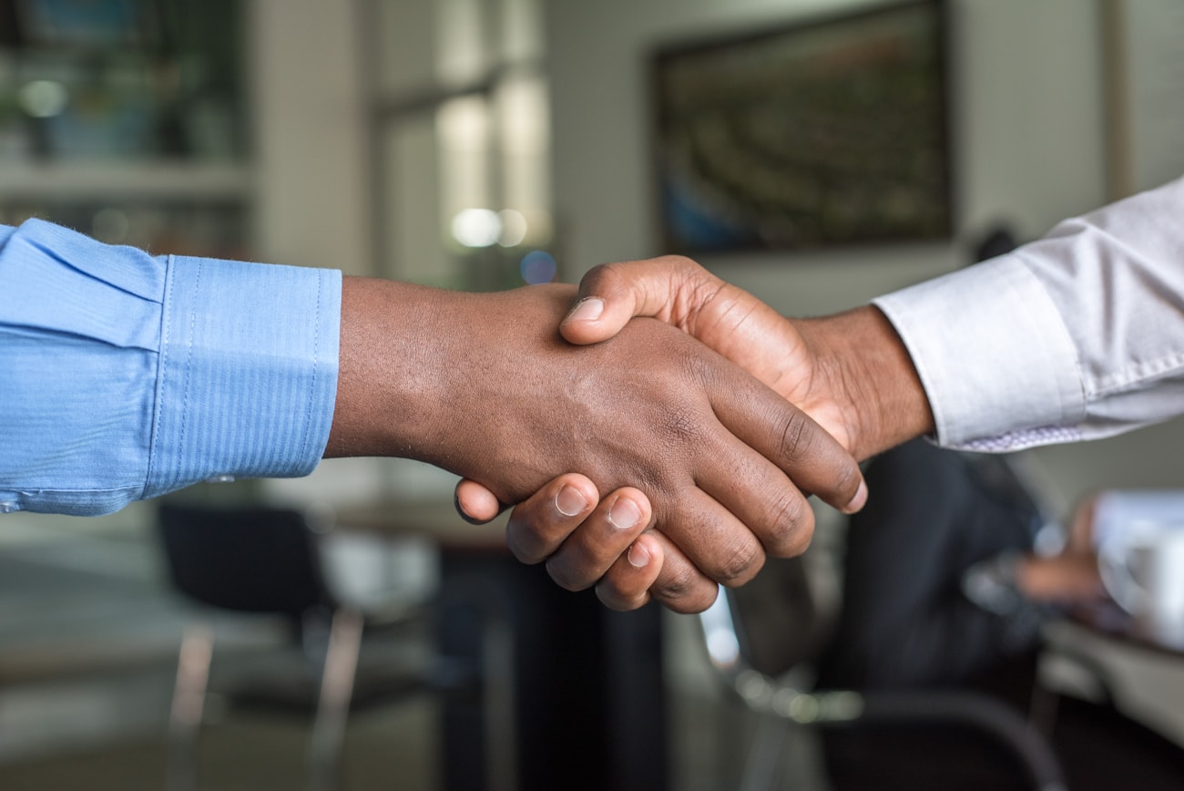 Shaking hands to start a new client engagement